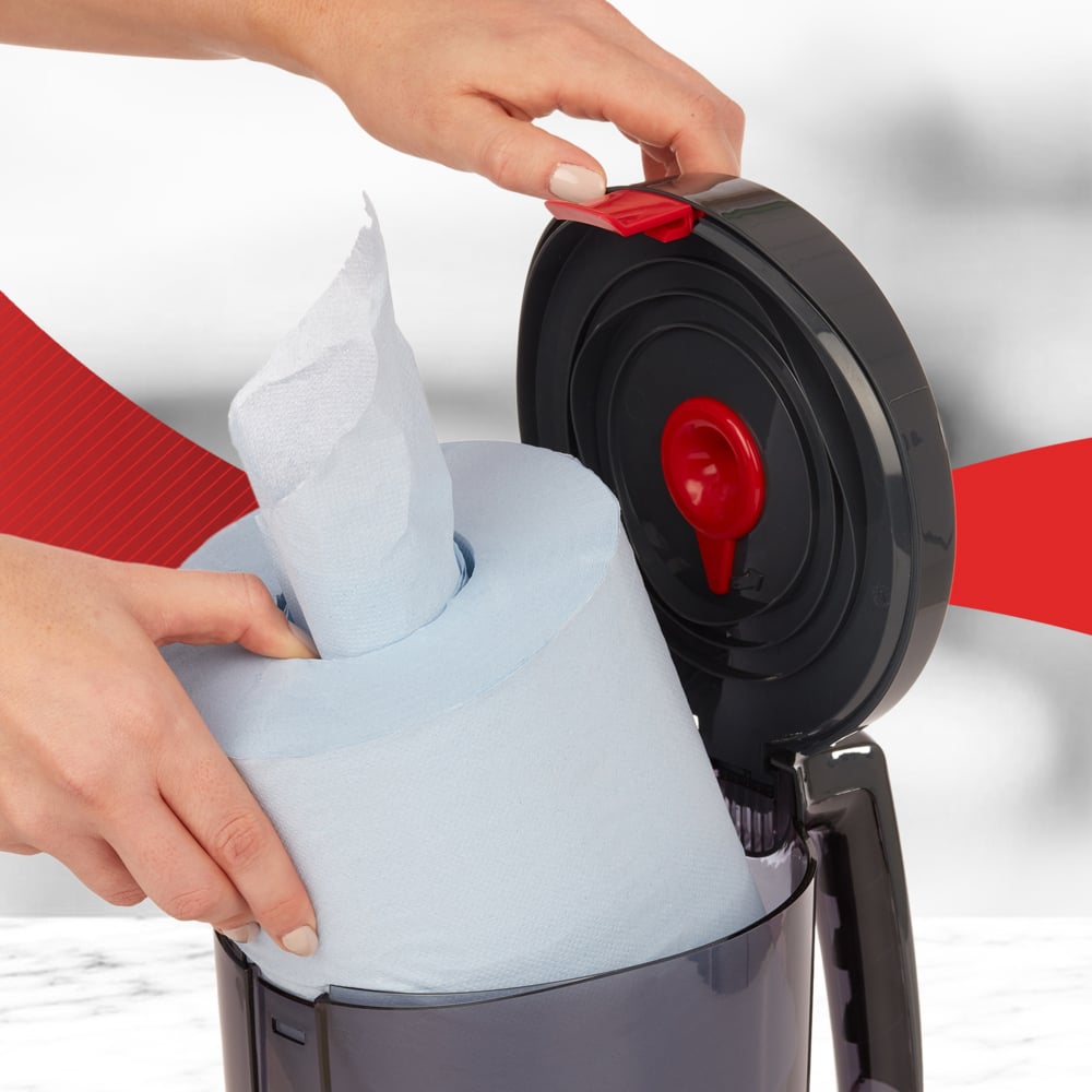 A Person Refilling a Black 6221 Centrefeed Dispenser with a Blue Paper Hand Towel Roll