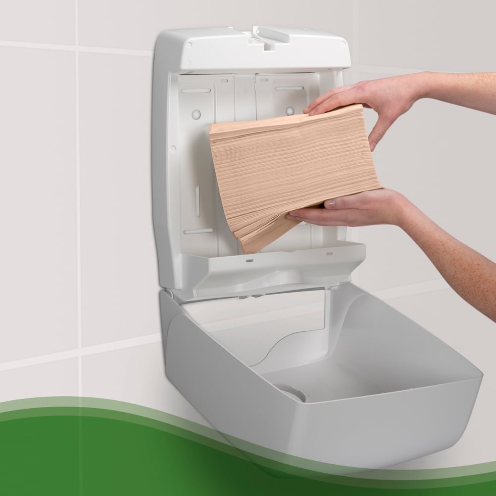 A Person Putting Brown Paper Hand Towels into a White 6832 Aquarius Hand Towel Dispenser