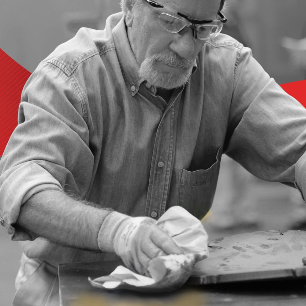 A Man Using Some White 7278 WypAll Paper Hand Towel to Clean