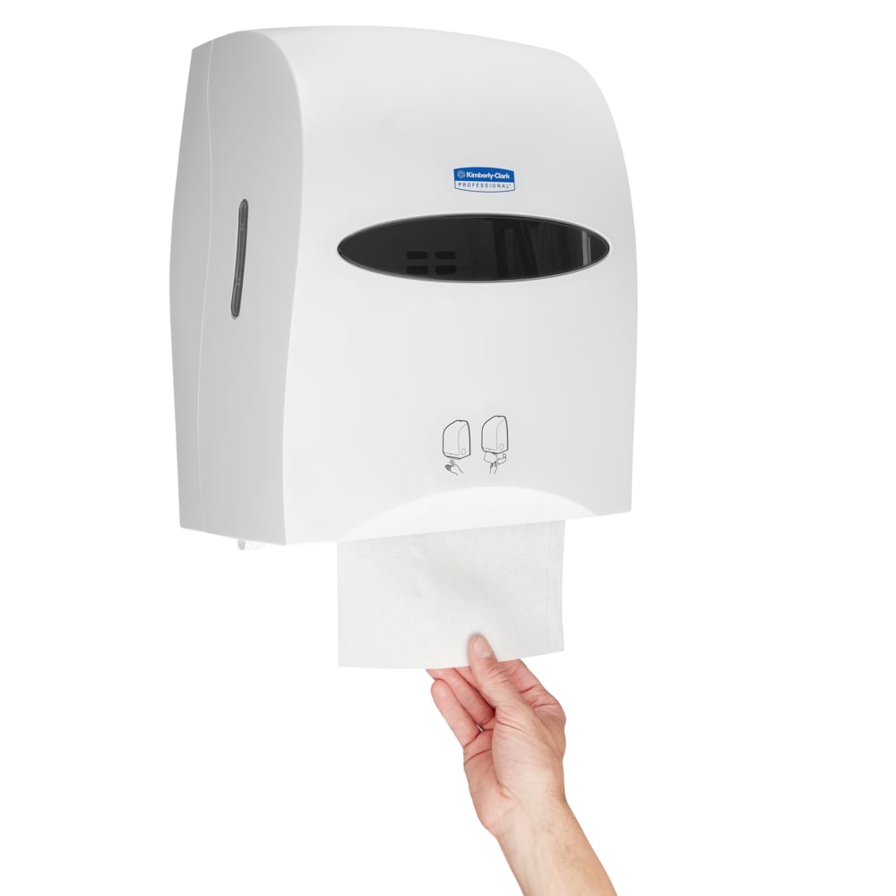 A Person Taking a White Paper Hand Towel from a White 9960 Kimberly Clark Paper Hand Towel Dispenser