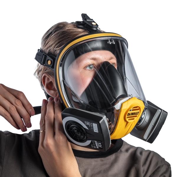 A Man Donning a Black, Yellow and Clear Visor DXIR1FFM DeWalt Face Mask with P3 Filters